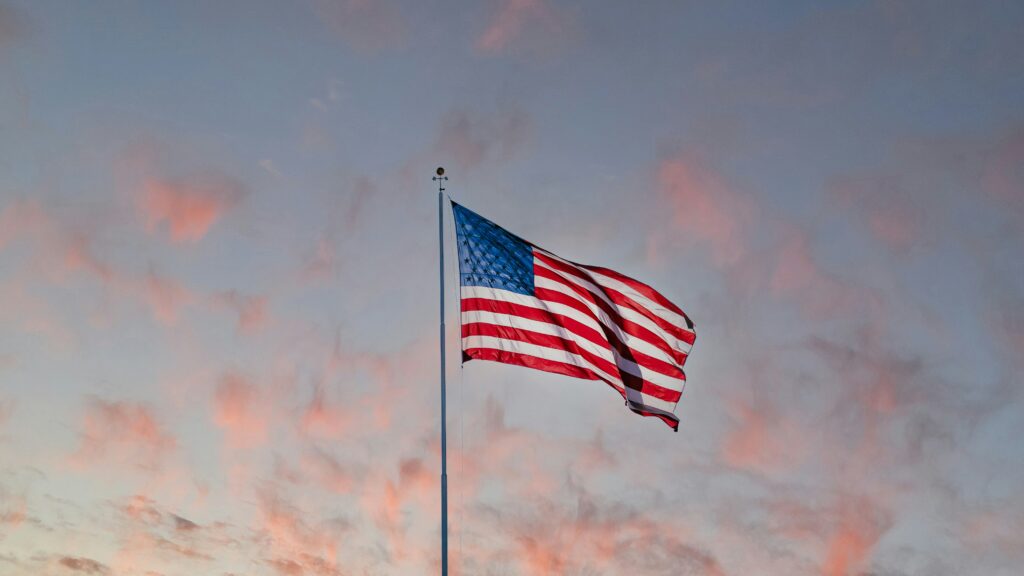 American flag in front of sunset